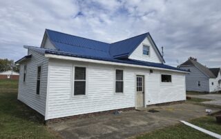 crisp white vinyl siding paired with a royal blue metal roof installation in greater indianapolis