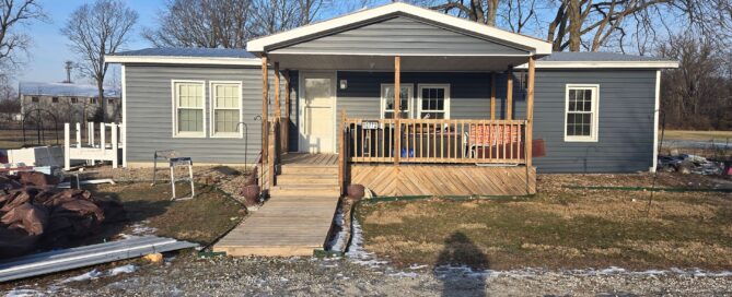 dark gray siding installation with natural wood porch and ramp by local contractor in noblesville indiana